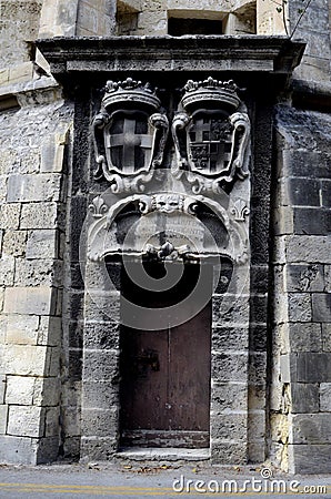 Old wooden Maltese door with two coats of arms in Valletta,Malta Stock Photo