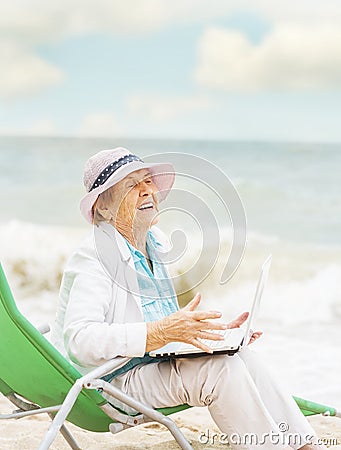 Very old wrinkled woman in a playful mood with a laptop Stock Photo