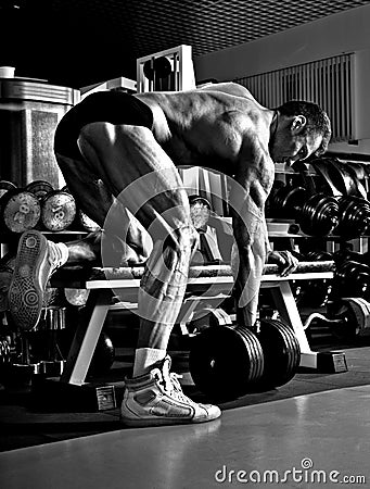 Very power athletic guy , execute exercise with dumbbells Stock Photo