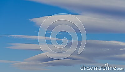 Very rare sighting of several lenticular clouds Stock Photo