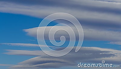 Very rare sighting of several lenticular clouds Stock Photo