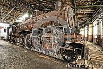Very rusty old steam engine in the historic depot Stock Photo