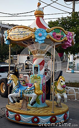 Very small colorful carousel merry go round. Editorial Stock Photo
