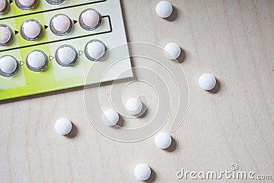 Very small white round pills Stock Photo