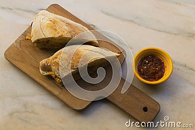 Very tasty big sandwich with meat stuffed and homemade crunchy and fluffy bread. It is a traditional portuguese pork beef sandwich Stock Photo
