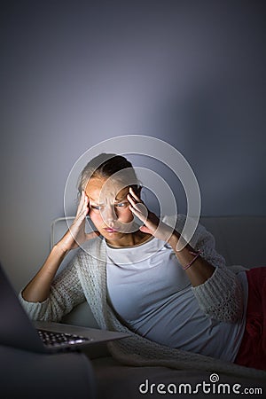 Very tired young woman, burning the midnigh oil Stock Photo