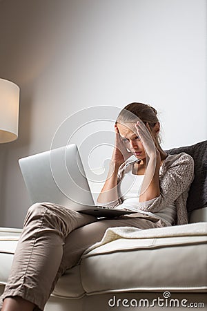 Very tired young woman, burning the midnight oil Stock Photo