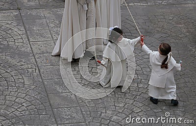 Young penitents playing before procession during Easter holy week in mallorca Editorial Stock Photo