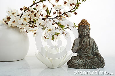 Vesak, Wesak, Buddha birthday. Buddha statue with blossoming cherry on white background. Spa ritual. Mental health and Stock Photo