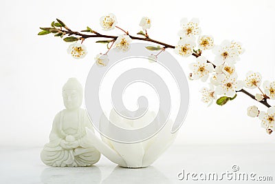 Vesak, Wesak, Buddha birthday. Buddha statue with blossoming cherry on white background. Spa ritual. Mental health and Stock Photo