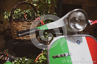 Vespa Piaggio motorcycle with a basket of chilies on display in Tropea, Calabria Editorial Stock Photo