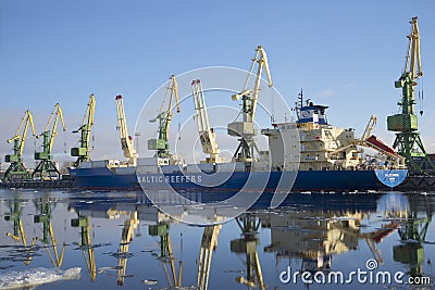 Vessel for transportation of containers-refrigerators Baltic spring is unloaded at the St. Petersburg cargo port Editorial Stock Photo