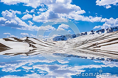 Vessels and spectacular reflections of the mountains snow Stock Photo