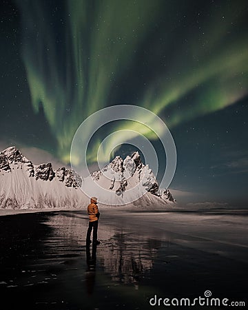 Vestrahorn mountain with aurora in south-east Iceland, covered by snow near the beach and sea in the winter Stock Photo