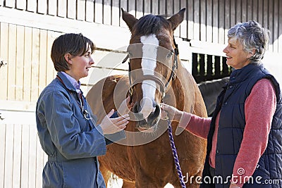 Vet In Discussion With Horse Owner Stock Photo