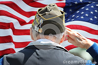 Veteran Saluting in front of US Flag Editorial Stock Photo