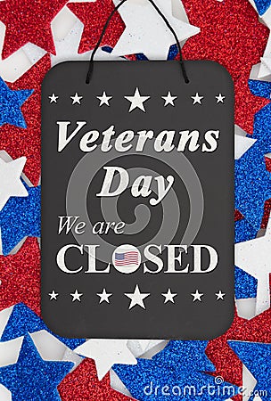 Veterans Day closed message on chalkboard with red, white and blue glitter stars Stock Photo