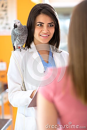 Veterinarian is giving advices to a girl in vet infirmary Stock Photo