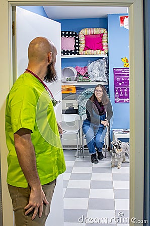 Veterinarian receiving a client with her pet Stock Photo
