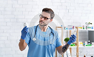 Veterinary treatment. Causacian vet doctor holding drugs for prescription in hospital Stock Photo