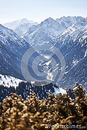 Vew from top of slope on snow capped mountains. Karakol ski resort in Kyrgyzstan Stock Photo