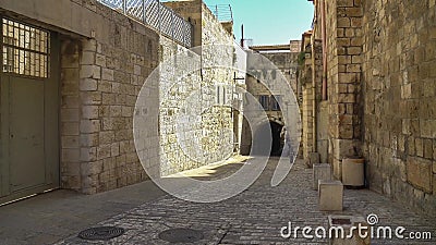 The Via Dolorosa is the narrow street inside the walled town Stock Photo