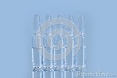 A vial ampoule, container with a drug on reflected surface Stock Photo