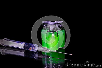 Vials with green toxic steroids and syringe Stock Photo