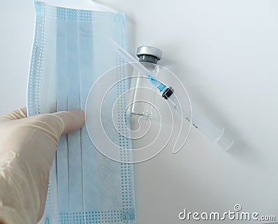 vials with infection vaccine, syringe, protective mask Stock Photo