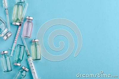 Vials and syringes on blue Stock Photo