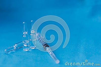 Vials to syringes at a hospital table, Hepatitis vaccine in clear vial. Immunization and treatment COVID 19 or corona virus Stock Photo