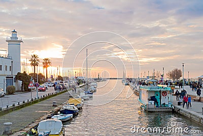 Sunset on dock and lighthouse, port of Viareggio (Tuscany) Editorial Stock Photo