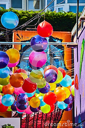 Vibrant and colorful hanging balloon balls with mural art Stock Photo