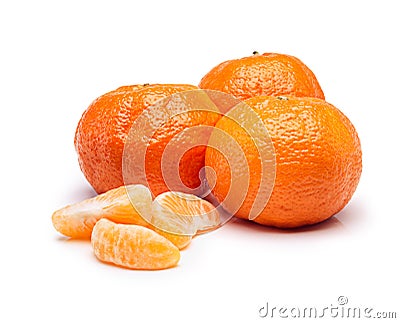 Vibrant fruit. Studio shot of tangerine slices beside whole fruits. Stock Photo