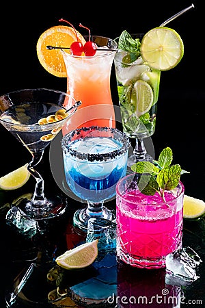 Vibrant glowing colourful cocktails against a black background. Stock Photo