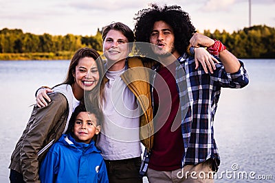 Diverse Friends and Child Enjoying Lakeside Camaraderie Stock Photo