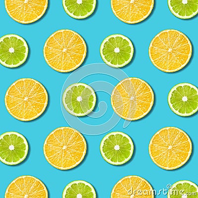 Vibrant lemon and green lime slices texture on turquoise background Stock Photo