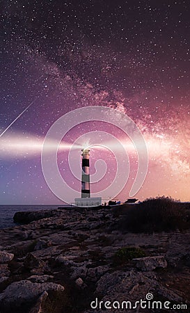 Vibrant Milky Way composite image over landscape Cap Artrutx Lighthouse on the mediterranean island of Menorca Stock Photo