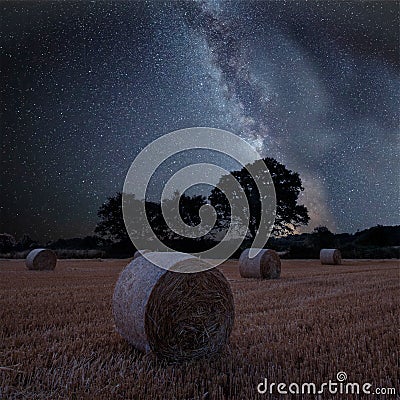 Vibrant Milky Way composite image over landscape of field of hay Stock Photo
