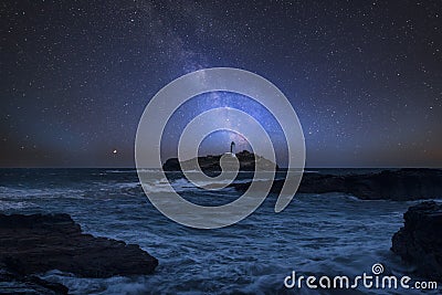 Vibrant Milky Way composite image over landscape of Godrevy Lighthouse in Corwnall England Stock Photo