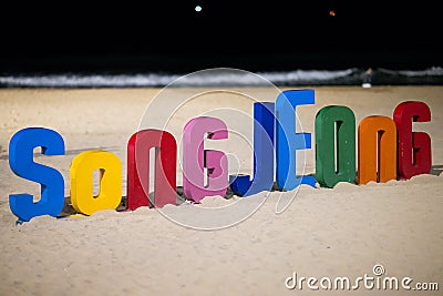 Vibrant sign spelling out the word "Song Jeong" displayed against a stunning beach landscape. Editorial Stock Photo