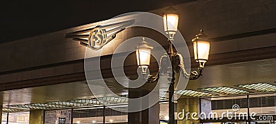 a storefront lit up at night with illuminated light fixture Editorial Stock Photo