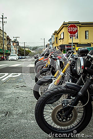 Vibrant street scene featuring an array of parked motorcycles on the side of the road. Editorial Stock Photo