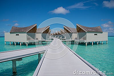 Vibrant tropical beach landscape of the over water bungalows at luxury resort in Maldives Stock Photo