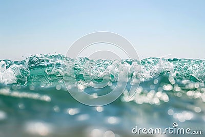 A vibrant wave in the ocean, captured in motion with a blurry effect, showcasing the fluidity and power of nature Stock Photo