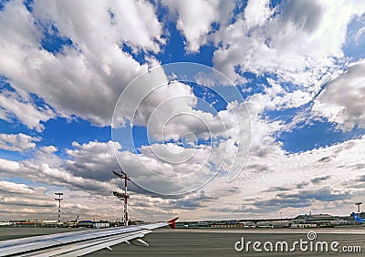 Vibrant wide angle view of aircraft flight in blue cloudy sky Stock Photo