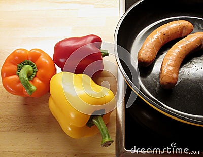 Vibrant Yellow, Red, Orange Color Ripe Bell-pepper and Grilled Sausages Stock Photo