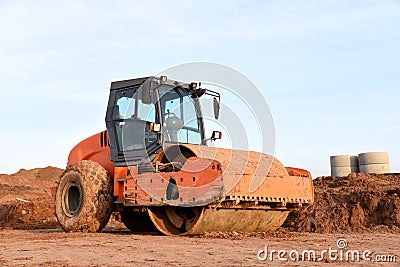 Vibration single-cylinder road roller leveling the ground for the foundation. Soil Compactor for laying asphalt Stock Photo