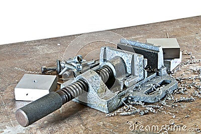 Vice with cuttings, screws and tools Stock Photo