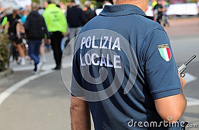 Vicenza, VI, Italy - October 9, 2022: policeman in uniform and text that means LOCAL POLICE in Italian Editorial Stock Photo